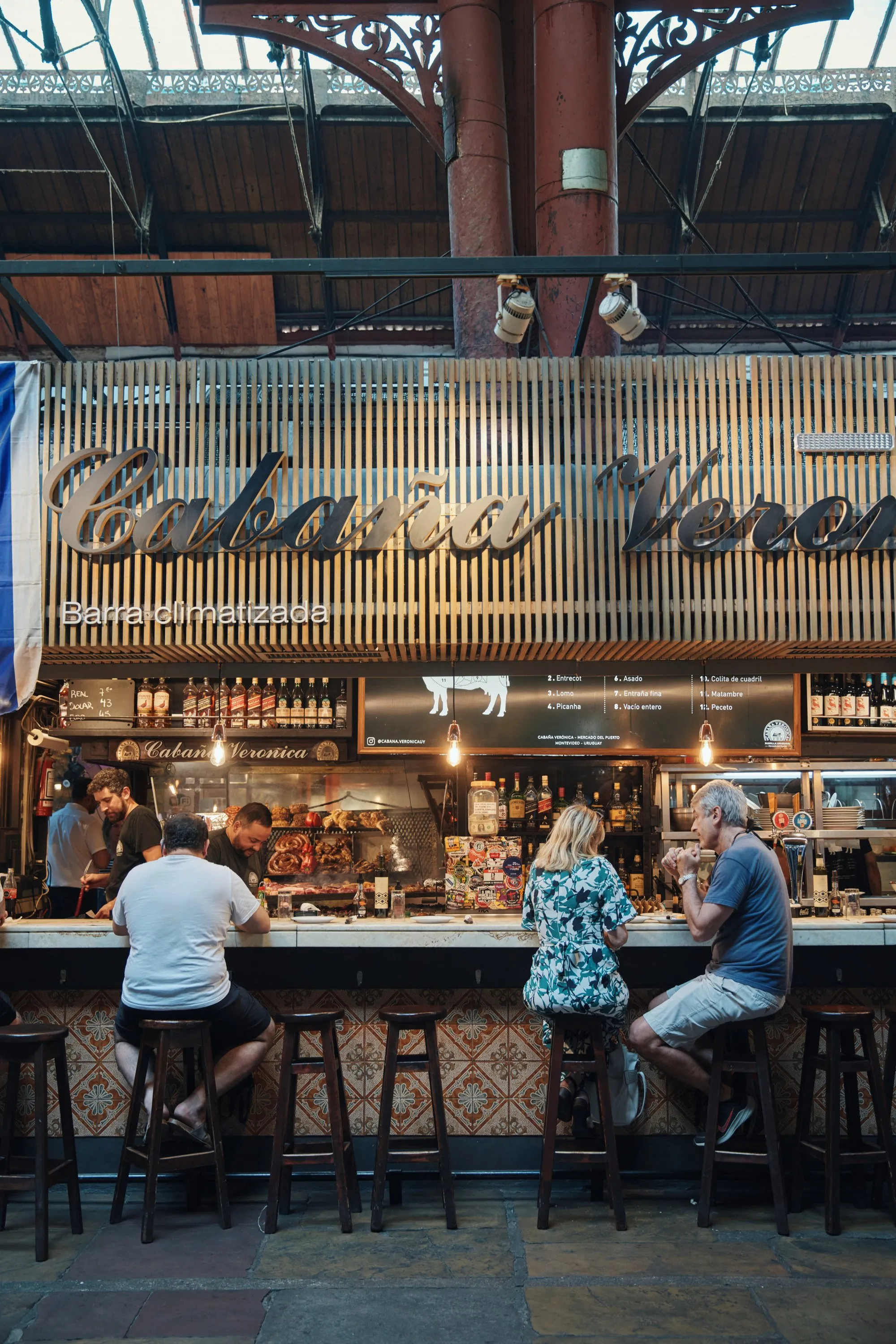 The counter at Cabaña Verónica in the Mercado del Puerto, people eating