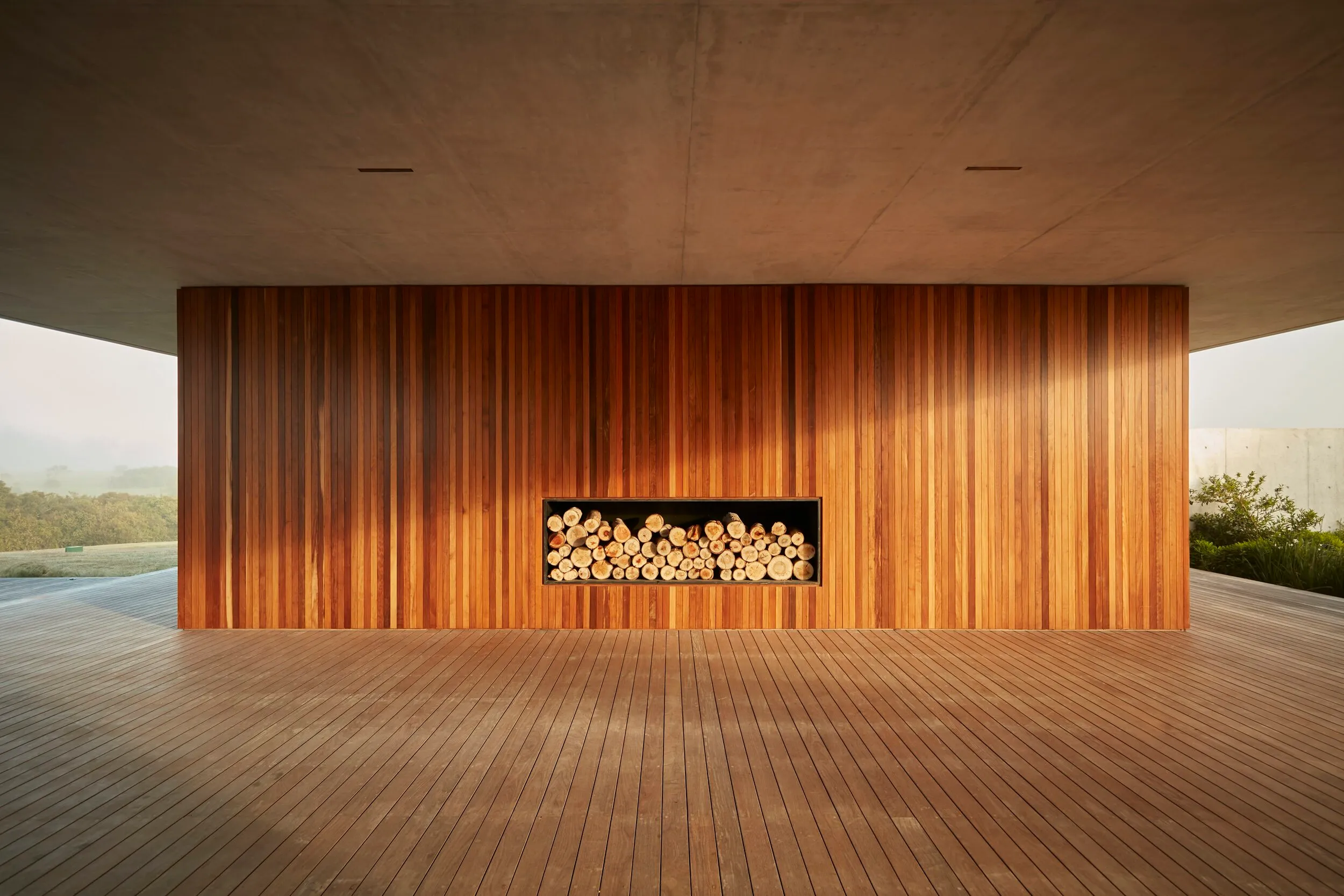 Wooden wall with a log shelf in a modern, open space.