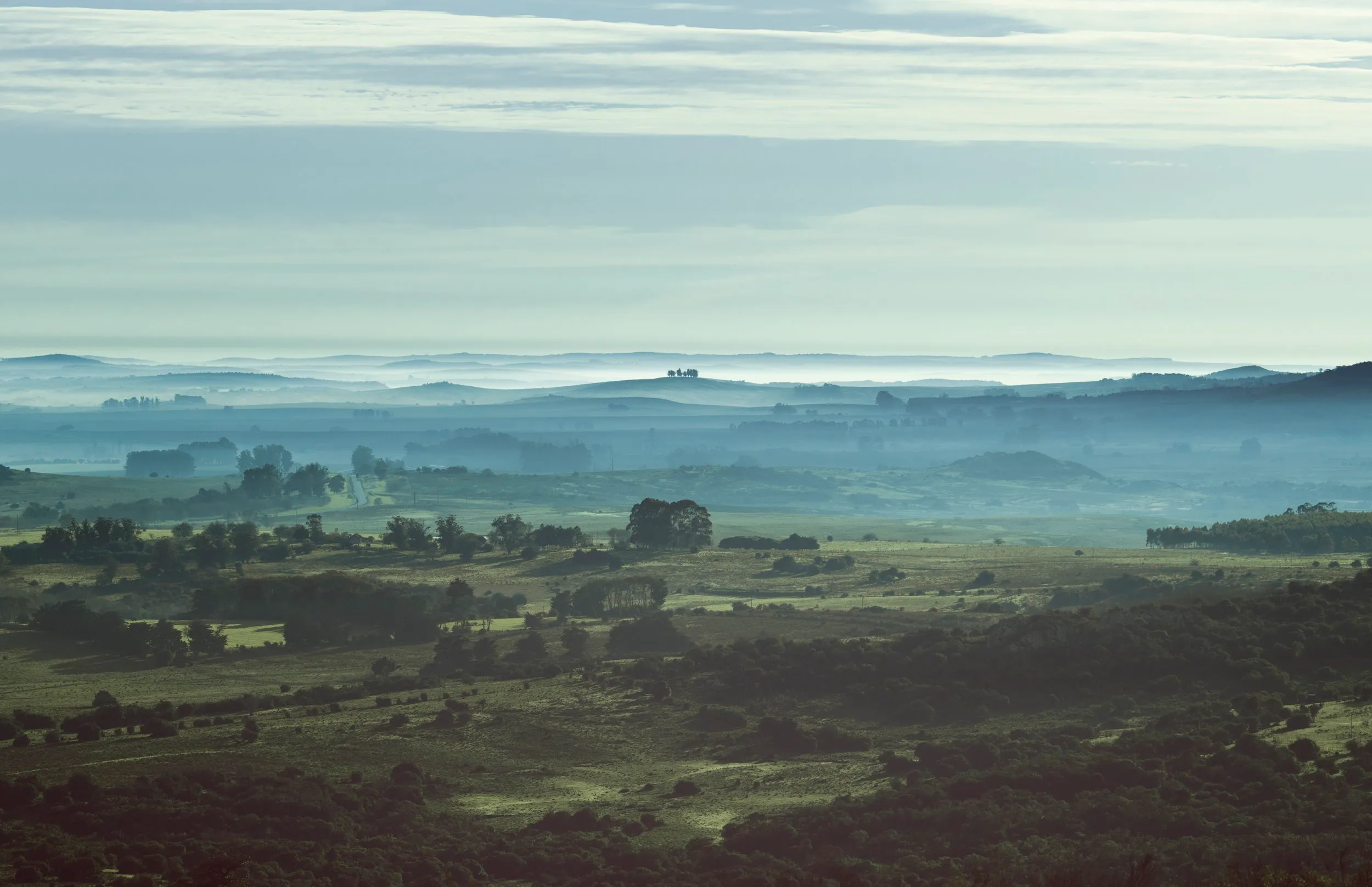 The hills of Villa Serrana in blue layers, in the morning haze