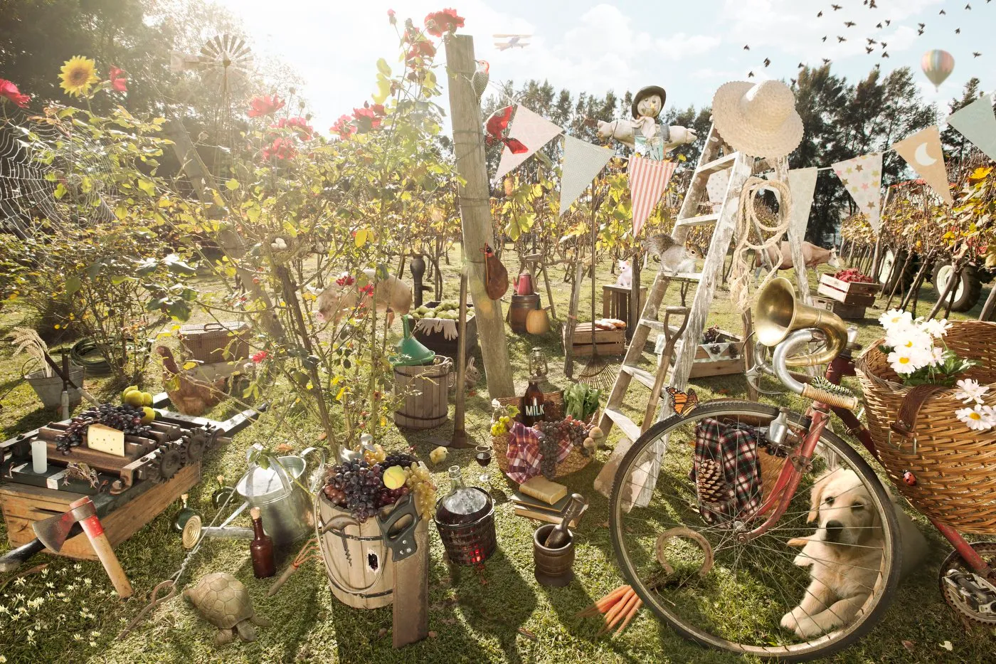 Countryside decor with a lemon tree, a bicycle with a basket of flowers, animal figurines, bunting, balloons, and vintage objects