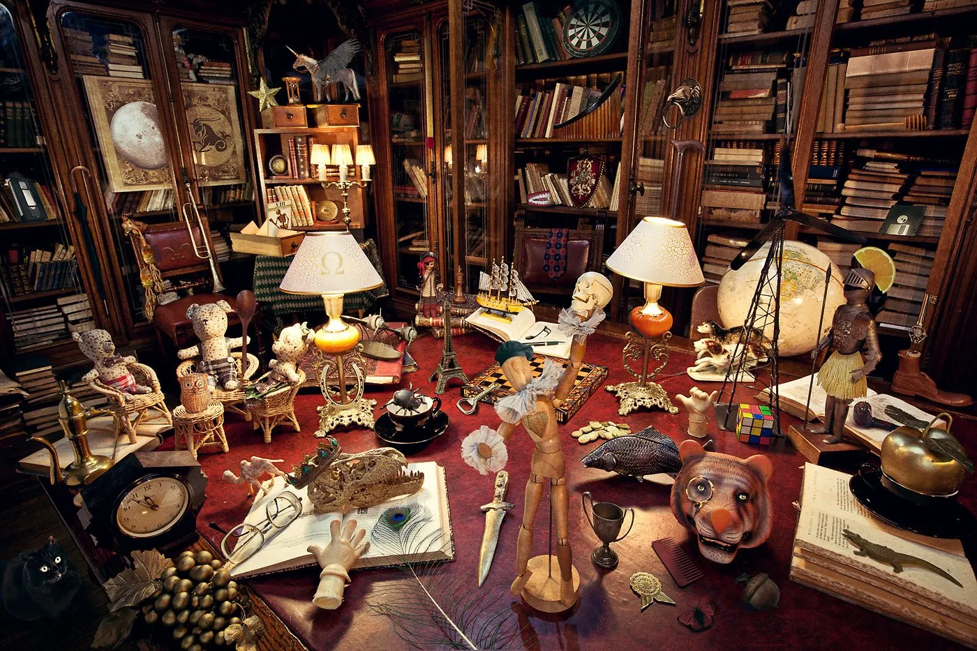 Shelves full of books, with decorative objects and various figures in an old office or bookshop.