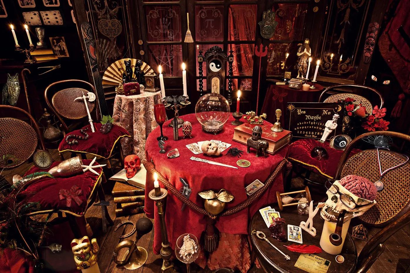 A table decorated with mystical, esoteric objects in a dark room, with lit candles, old books, and mysterious ornaments.